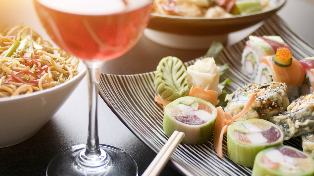 Glass of wine with a sushi plate.